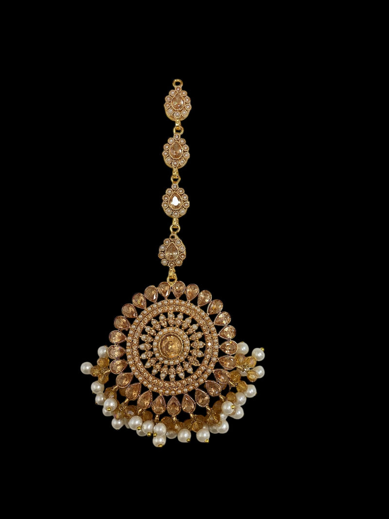 Champagne gold maang tikka adorned with delicate pearls | Features intricate craftsmanship with a luxurious finish | A perfect accessory for weddings, festive occasions, and bridal looks | Timeless South Asian jewelry piece that complements sarees, lehengas, and ethnic outfits | Lightweight yet elegant for a regal touch | Elevate your traditional ensemble with this exquisite pearl maang tikka, designed for grace and sophistication.