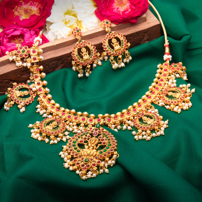 Necklace Set in gold with ruby and emerald stones and pearls. comes with earrings. perfect for Indian tradiditional jewelry.