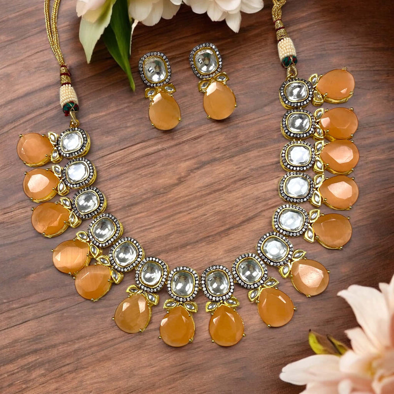 A stunning Peach Shibani Kundan Necklace Set featuring uncut Kundan, sparkling American Diamonds, and elegant peach Monalisa beads in a gold-plated finish. Perfect Indian bridal jewelry for weddings, festivals, and special occasions.