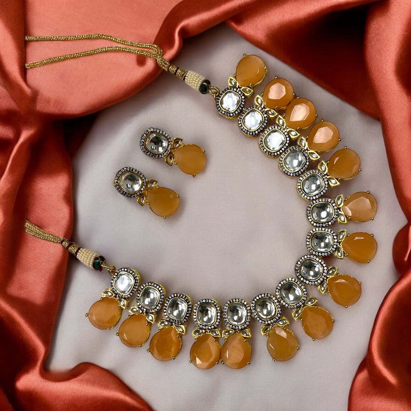 Peach Shibani Kundan Necklace Set featuring intricate uncut Kundan, sparkling American Diamonds,and soft peach Monalisa beads in gold plating. Ideal for weddings, festive occasions, and traditional celebrations as a stunning ethnic jewelry piece.