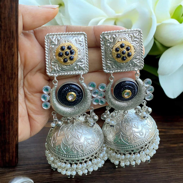 Sunehri 92.5 silver-coated black jhumka earrings with pearl drops. Traditional Indian jewelry featuring a bold black dome, intricate silver detailing, and delicate white pearls. Perfect for weddings, festivals, and ethnic outfits.