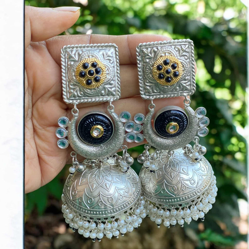 Elegant 92.5 silver-plated black jhumka earrings with delicate pearl hangings – handcrafted traditional Indian earrings perfect for weddings, Diwali, and festive occasions. Featuring intricate silver work and a bold black finish, these ethnic earrings pair beautifully with sarees, salwar suits, and lehengas. A must-have accessory for South Asian bridal and festive fashion.