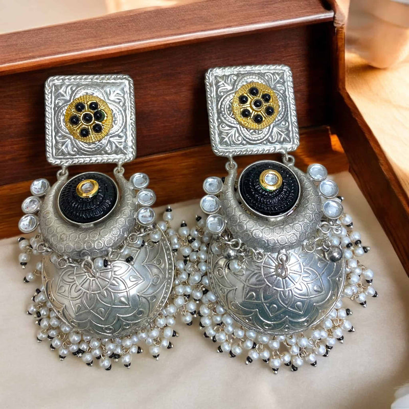 92.5 silver-coated black jhumka earrings with pearl drops – traditional Indian jewelry featuring a handcrafted black dome, intricate silver detailing, and elegant white pearls. Perfect for weddings, festive occasions, and ethnic outfits. These statement earrings offer a timeless blend of heritage design and modern elegance, ideal for pairing with sarees, lehengas, and Indo-western ensembles.