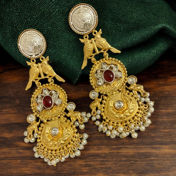 92.5 silver-plated long earrings with a gold finish, featuring a center ruby stone, intricate Kundan work, and a bird motif. Elegant South Asian jewelry perfect for weddings, festive occasions, or traditional attire.