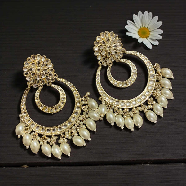 Traditional gold plated Kundan chandbali earrings with pearl hangings, crafted with intricate detailing and shimmering stones. These handcrafted Indian earrings showcase timeless elegance and rich artistry, perfect for brides, festive celebrations, and special occasions. The gold finish and pearl accents add a regal touch, making them a stunning accessory for sarees, lehengas, or party outfits.