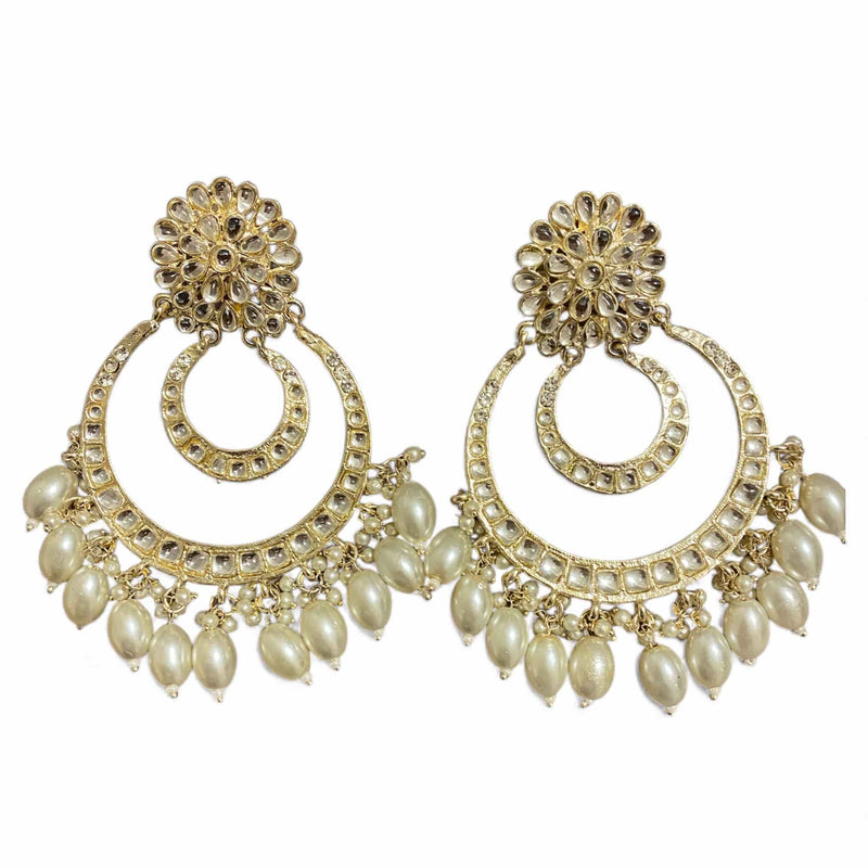 Close-up of gold plated Kundan chandbali earrings with pearls, highlighting the intricate stonework and handcrafted detailing. These elegant earrings feature a circular traditional design with shimmering Kundan stones and delicate pearl drops. Perfect for weddings, parties, and festive occasions, they reflect the beauty of Indian craftsmanship and timeless ethnic elegance.