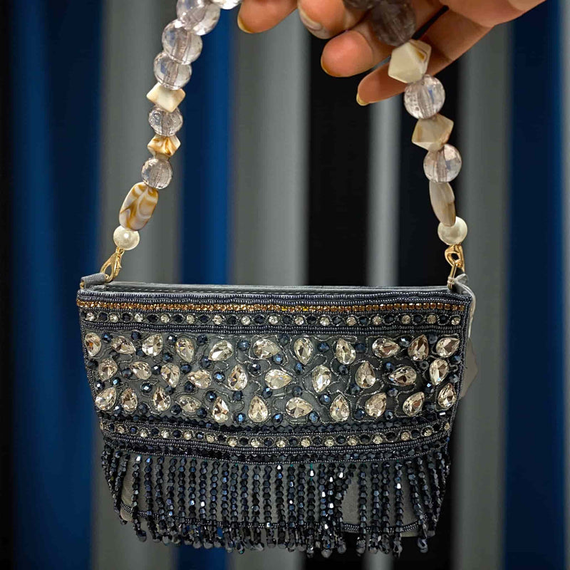 Shop this elegant grey beaded purse with high-quality stone work and crystal handle from Romikas Jewelry Shop. Handmade Indian clutch with intricate bead detailing, perfect for weddings, parties, and festive occasions. A luxury evening bag that complements sarees, lehengas, and gowns beautifully.