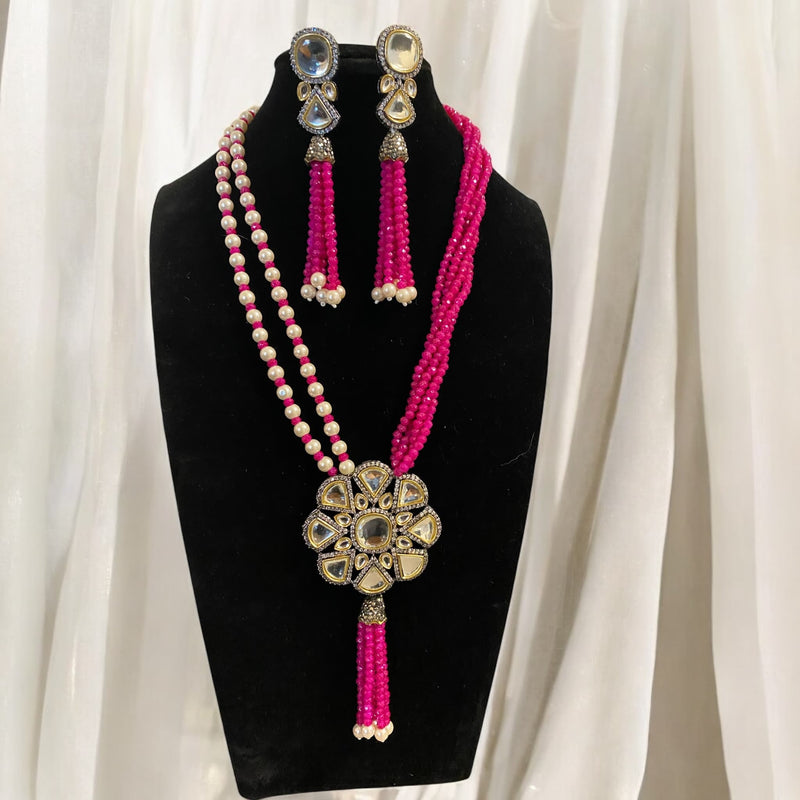 Hot pink long Kundan necklace set with silver-foiled Kundan stones, hot pink beads, and pearls. Comes with matching earrings, making it an ideal choice for weddings, festive events, and traditional Indian bridal wear.