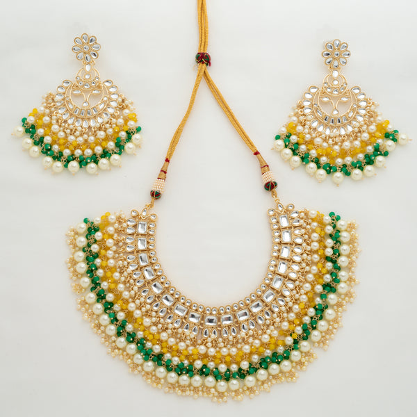 Featuring Indian Jewelry, this is a necklace featuring kundan, yellow and green beads and pearls. Set comes with an adjustable necklace and earrings.