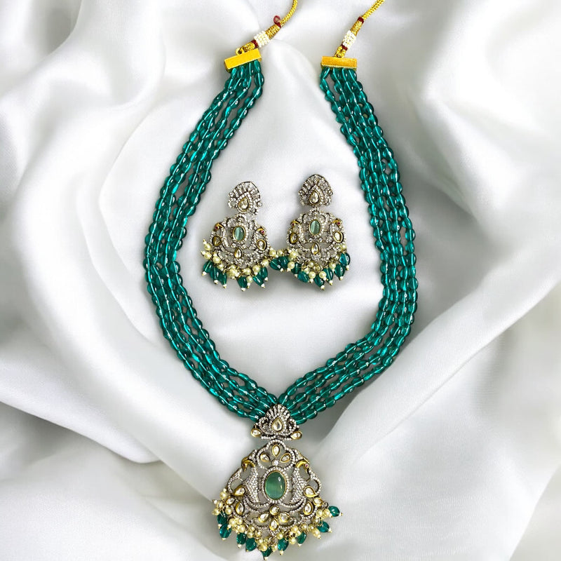 Long mala necklace set with seagreen beads, silver foil Kundan, and cubic zirconia in Victorian (Mangat Rai) finish | South Asian jewelry | Elegant necklace with dual peacock motifs and turquoise stone center | Includes matching earrings |