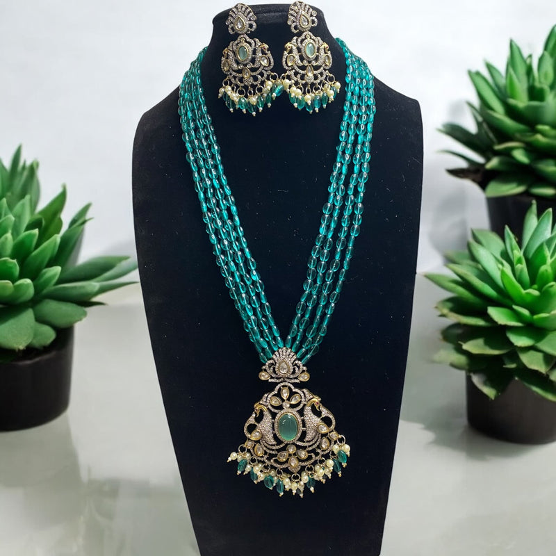 Indian Long Mala in Victorian finish from online jewelry store. Kundan long necklace set. The pendant and earrings have a peacock motif in cubic zirconia.