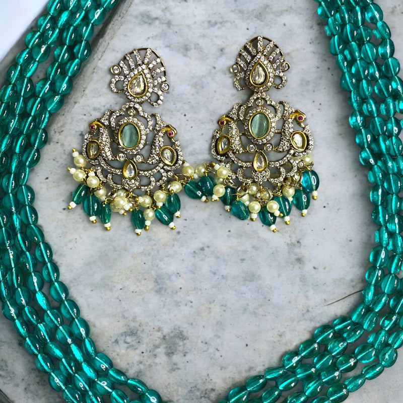 Elegant South Asian long mala necklace set | Seagreen beads, silver foil Kundan, and cubic zirconia in Mangat Rai finish | Features dual peacock motifs with turquoise center stone | Comes with matching earrings | Perfect for weddings l