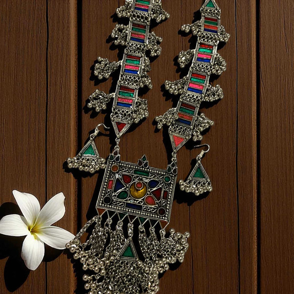 Beautiful Aradhya German Silver Multicolor Ghungroo Necklace with handcrafted oxidized silver detailing and vibrant enamel accents. This bohemian statement necklace features hanging ghungroos that create a charming ethnic sound. Perfect for pairing with sarees, lehengas, or Indo-western outfits, this unique tribal jewelry adds a colorful, artistic touch to festive, wedding, or everyday looks.