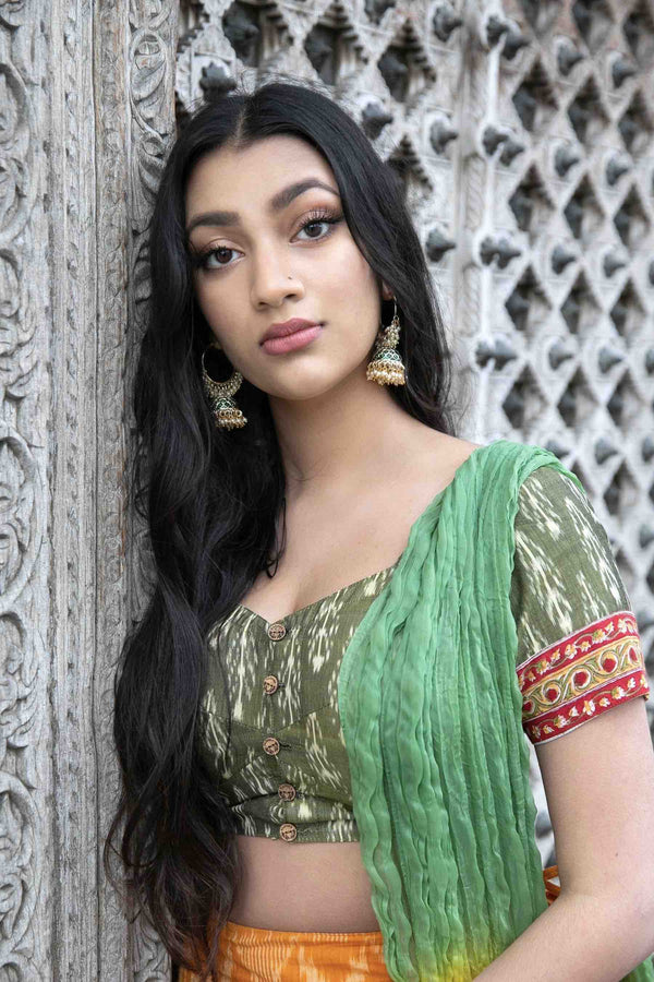 Model wearing emerald Mishti gold-plated earrings - Romikas