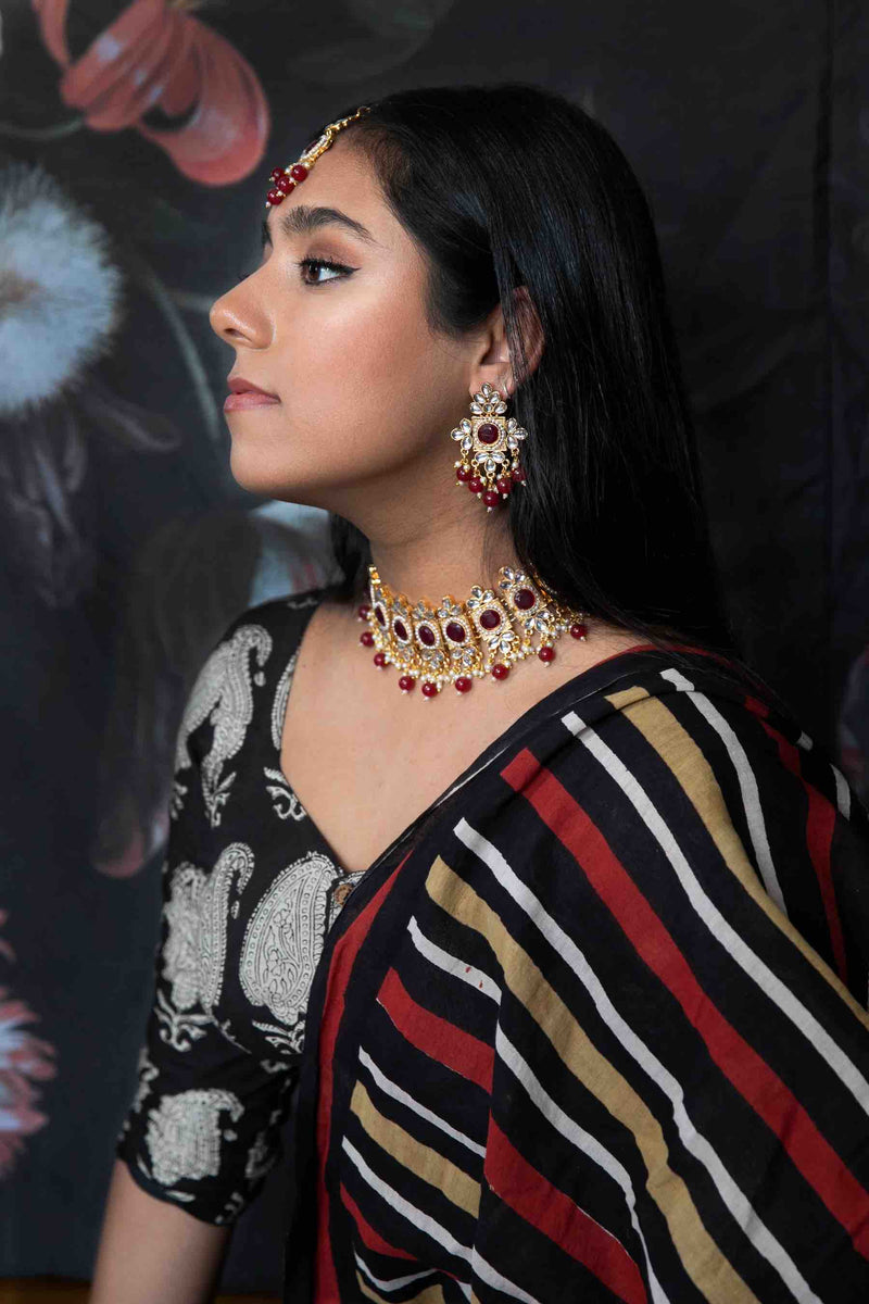 Model wearing red Amrita jewelry set - Romikas